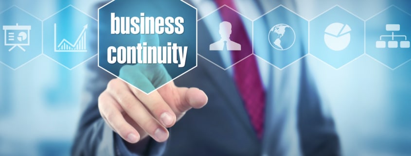 man in a suit shown from the shoulders down selects a floating icon with the words "business continuity"