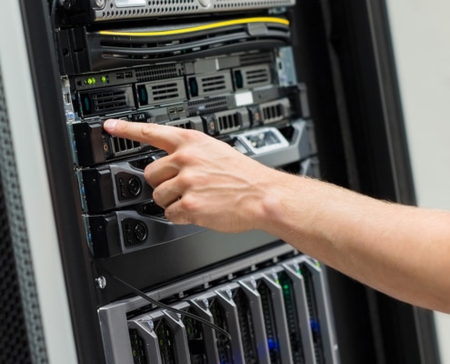 IT Engineer Switching On Server At Datacenter Closeup