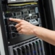 IT Engineer Switching On Server At Datacenter Closeup