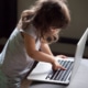 Child Pressing Buttons on a Laptop