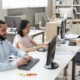 group of employees working on computer in office with managed cloud service provider support