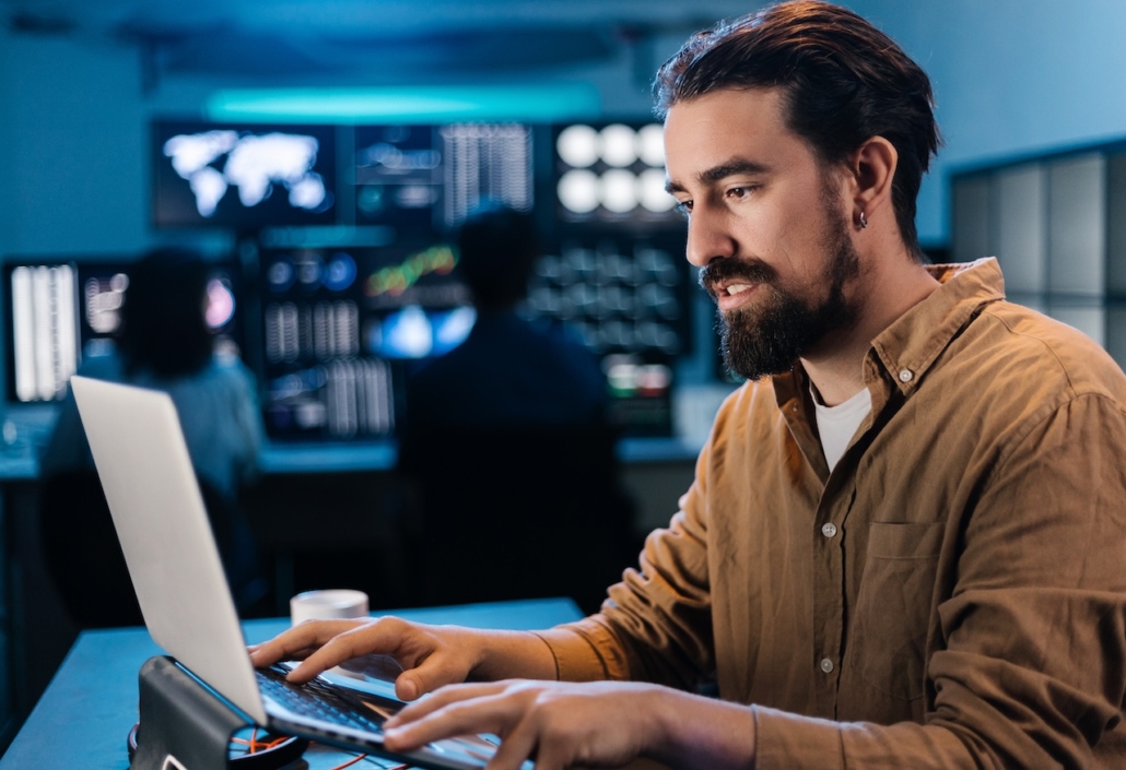 business employee working on computer, enlisting cybersecurity consulting services to stay protected while performing tasks