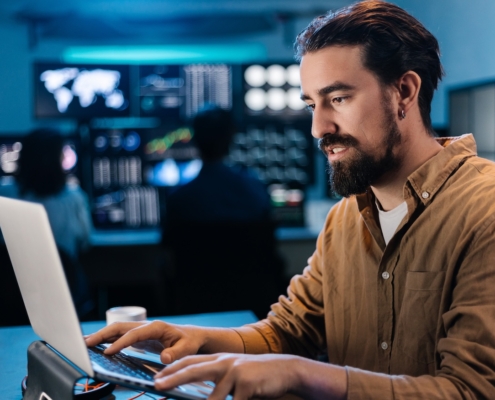 business employee working on computer, enlisting cybersecurity consulting services to stay protected while performing tasks