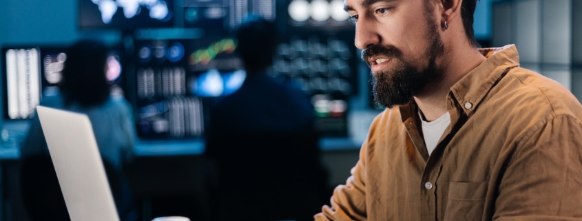 business employee working on computer, enlisting cybersecurity consulting services to stay protected while performing tasks