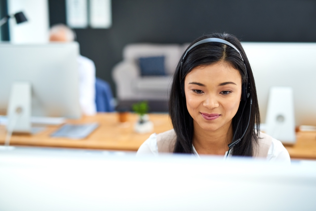 coworkers in office using managed cloud solutions to collaborate