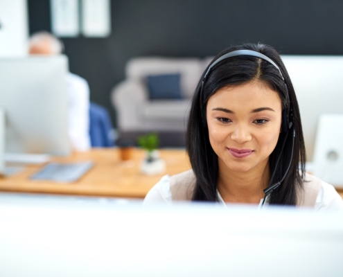 coworkers in office using managed cloud solutions to collaborate