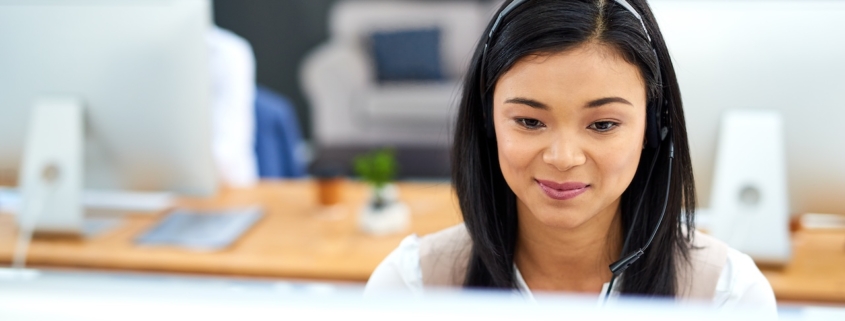 coworkers in office using managed cloud solutions to collaborate