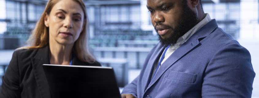 coworkers on computer using risk management tools for their small business