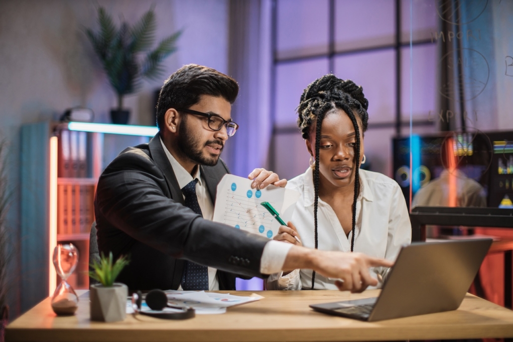 two coworkers in office working on computer with managed IT services