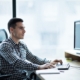 man working on computer in office avoiding network vulnerabilities with IT support