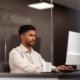 man working in office on computer using IT support and managed services