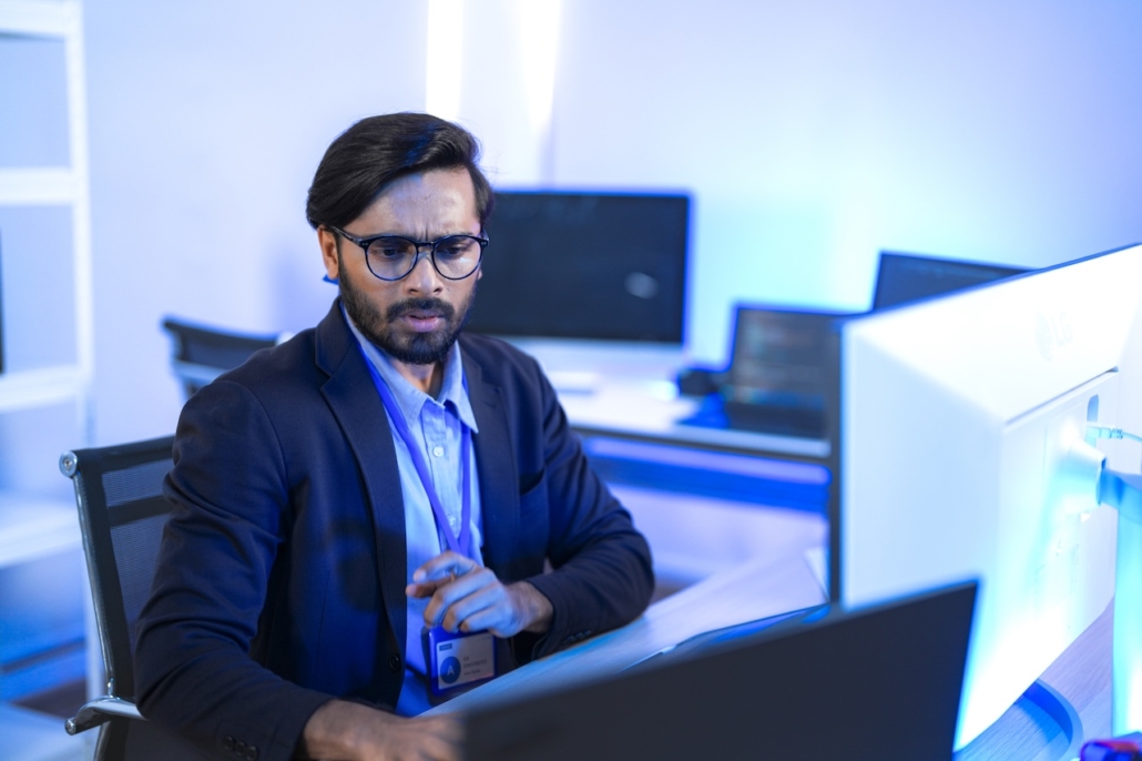 man working on computer in office with proper network security