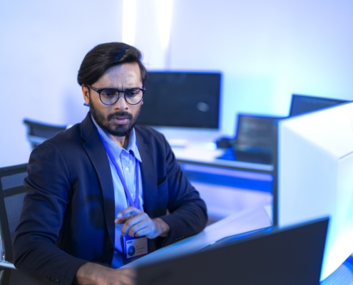 man working on computer in office with proper network security