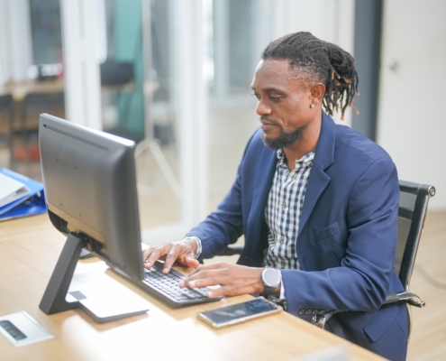man working on computer in office