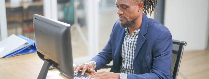 man working on computer in office