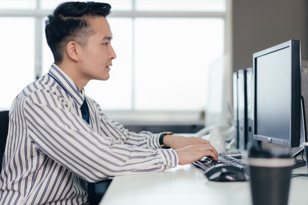 man working in office on computer
