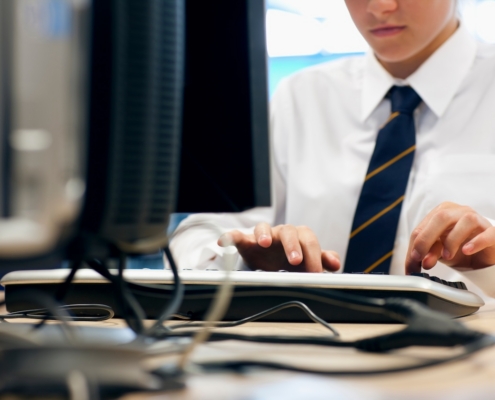 employee typing on computer at work