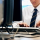 employee typing on computer at work