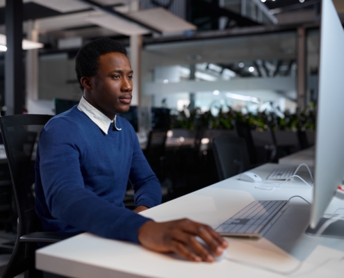 male employee working on computer in modern office