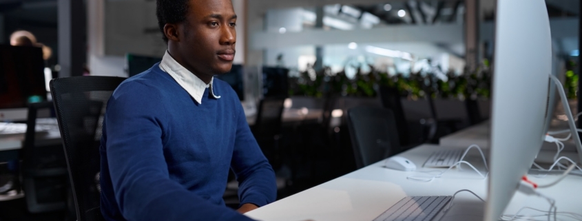 male employee working on computer in modern office