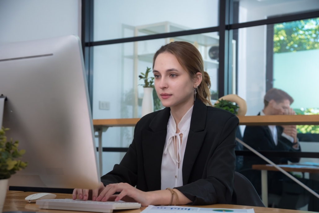 Focused businesswoman works diligently at modern office desk