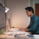 man working on computer in dimly lit office